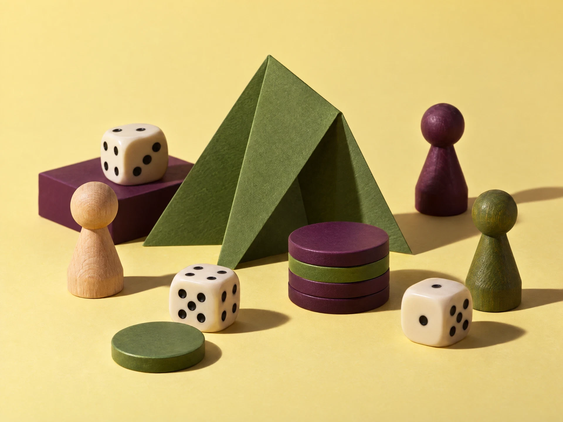 Generic dice counters and wooden pawns on butter yellow background